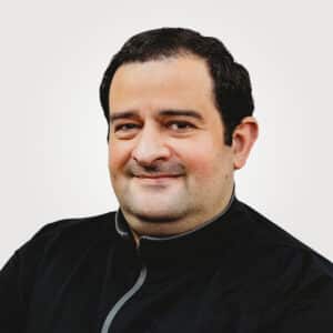 Beshar Bahjat, in leadership and technology at Interpro, smiling in a professional headshot wearing a black polo shirt.