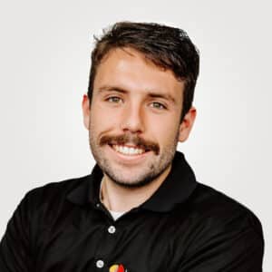 David Benigni, in sales at Interpro, smiling in a professional headshot wearing a black polo shirt.