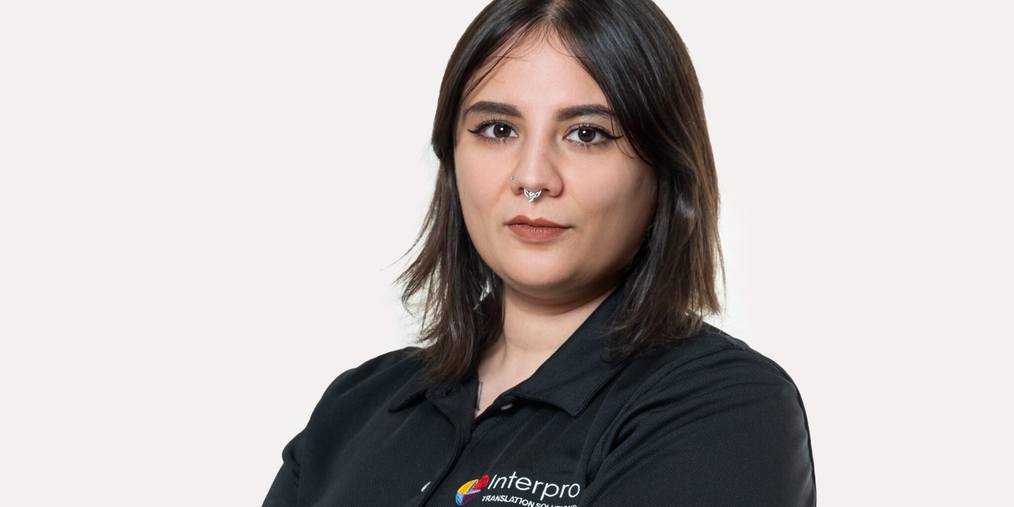 Javiera Gonzalez, woman with white background and black polo