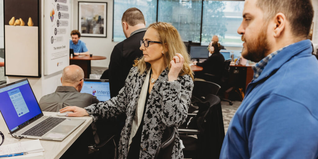 Team collaborating in an office setting during a translation needs assessment discussion.