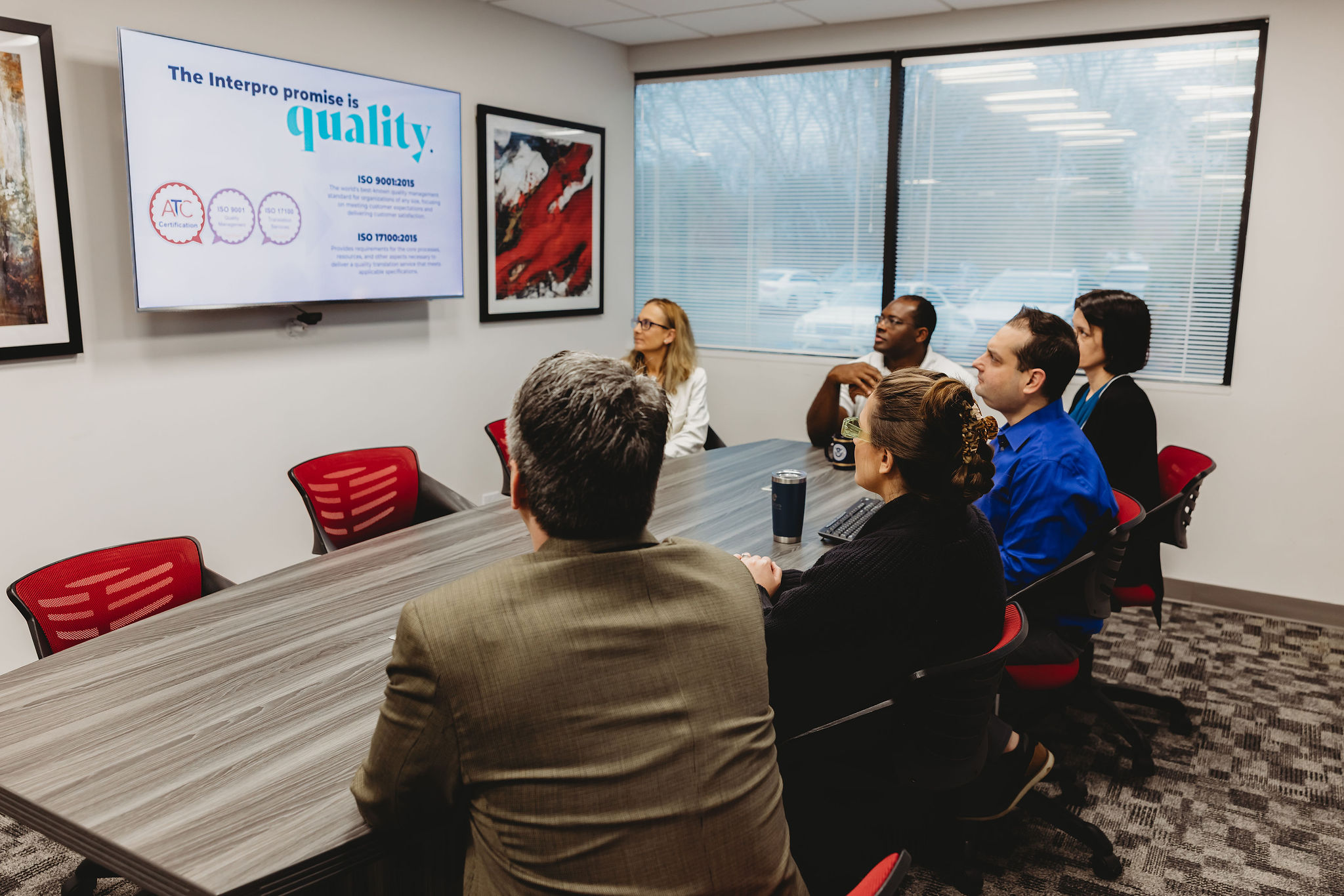 Interpro team meeting reviewing quality standards during a translation needs assessment.