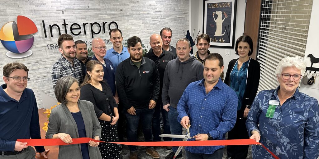 Team members of Interpro gathered in the lobby of the headquarters to participate in ribbon cutting.