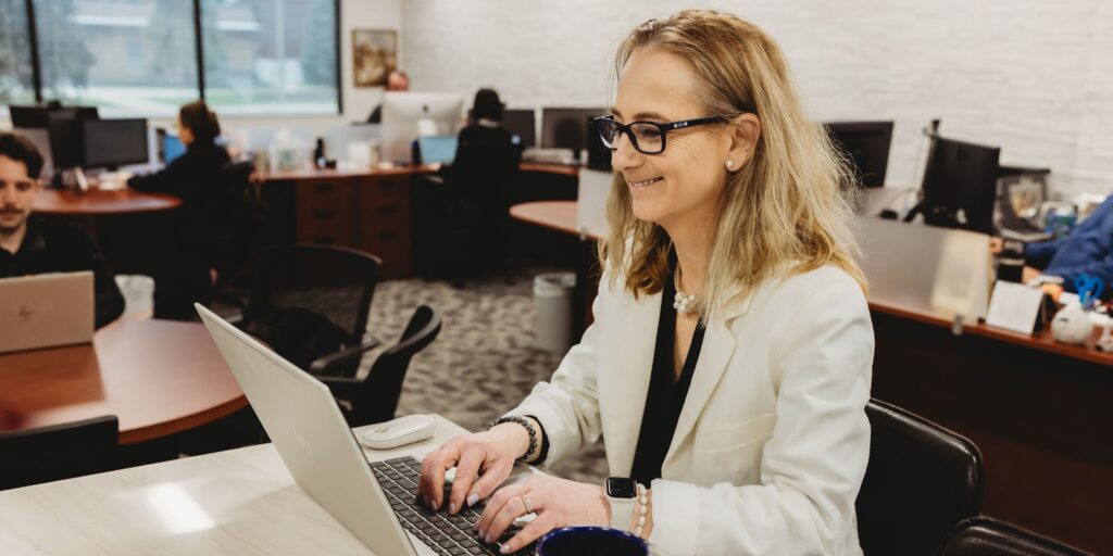 Maria Fagrelius, woman with white background and black polo
