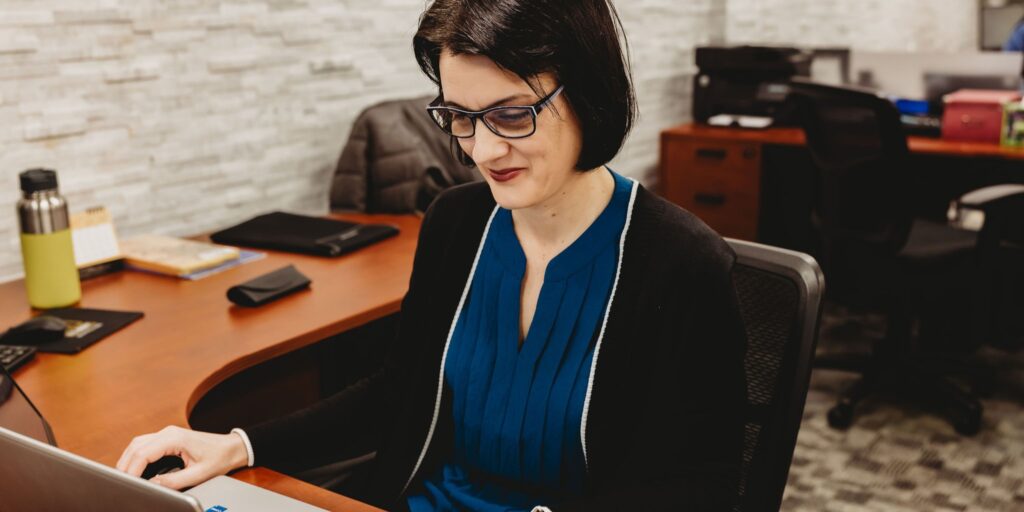 Mirela at a desk at Interpro's office
