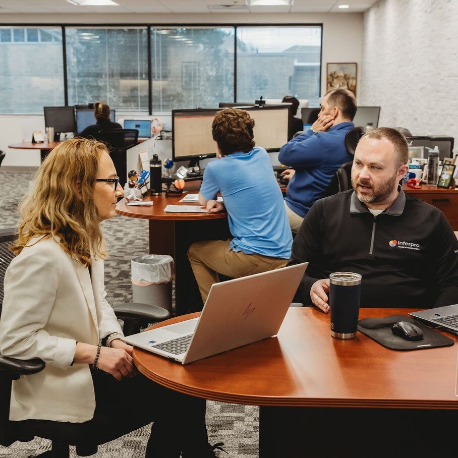 Interpro team collaborating on AI translation strategies in an open office