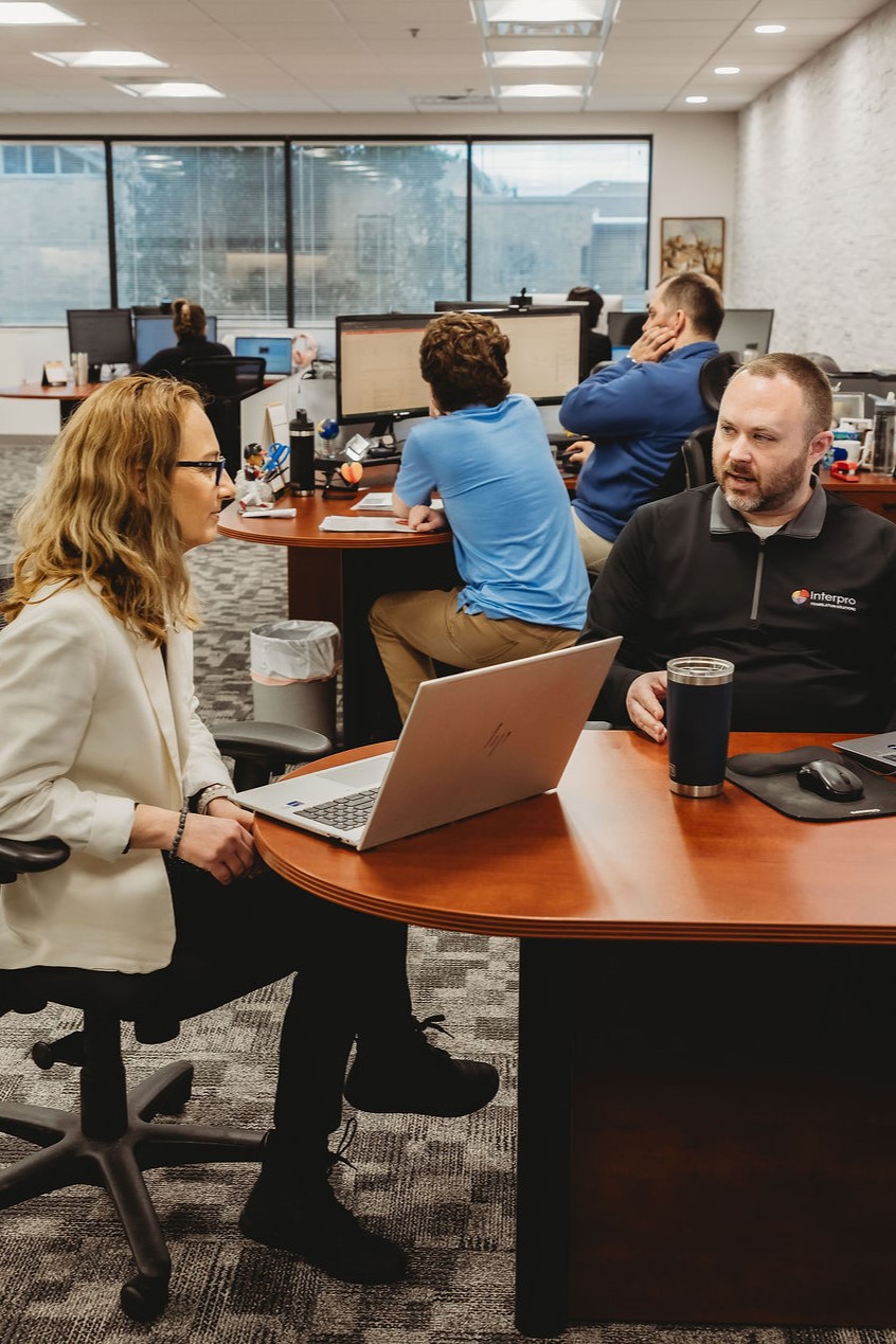 Interpro team collaborating on AI translation strategies in an open office