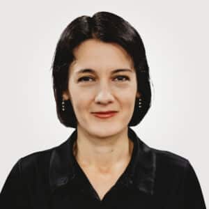 Mirela Savulescu, in project management at Interpro, smiling in a professional headshot wearing a black polo shirt.