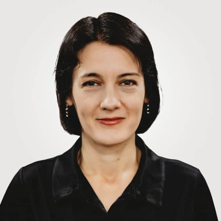Mirela Savulescu, in project management at Interpro, smiling in a professional headshot wearing a black polo shirt.